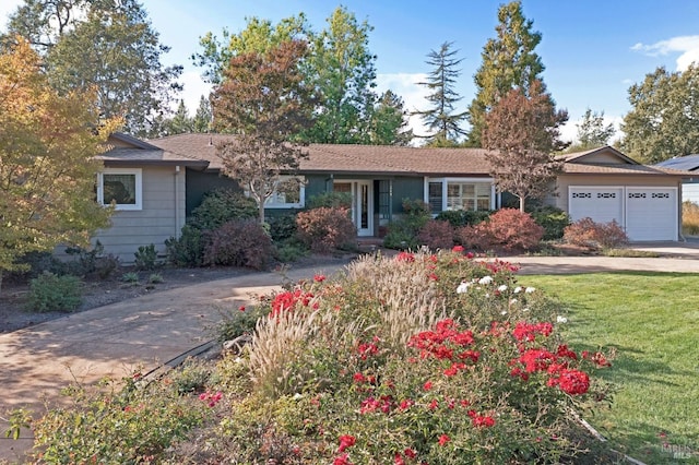 ranch-style home with a front lawn and a garage