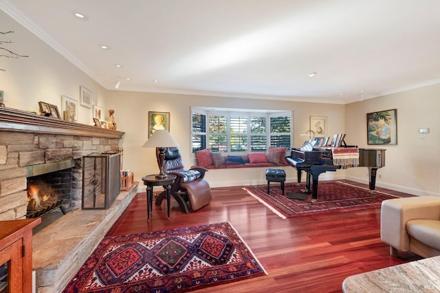 living room with ornamental molding, hardwood / wood-style flooring, and a fireplace