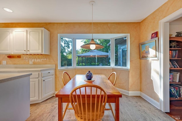 dining space with light wood-type flooring