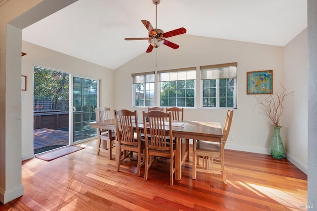 dining space featuring light hardwood / wood-style floors, ceiling fan, and vaulted ceiling