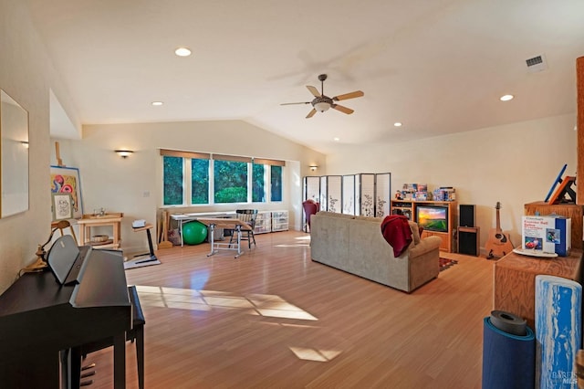 living room with lofted ceiling, light wood-type flooring, and ceiling fan