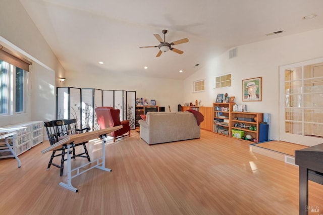 living room with ceiling fan, vaulted ceiling, and hardwood / wood-style floors