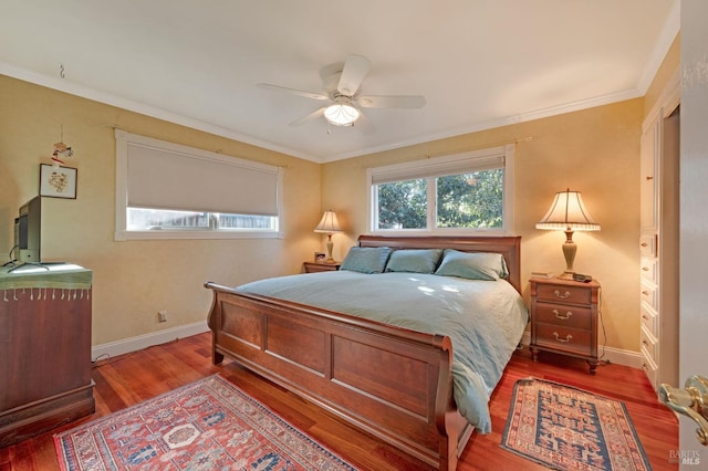 bedroom with ceiling fan, hardwood / wood-style flooring, and crown molding