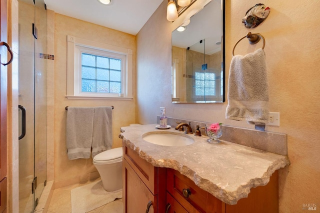 bathroom with vanity, a shower with shower door, toilet, and tile patterned floors