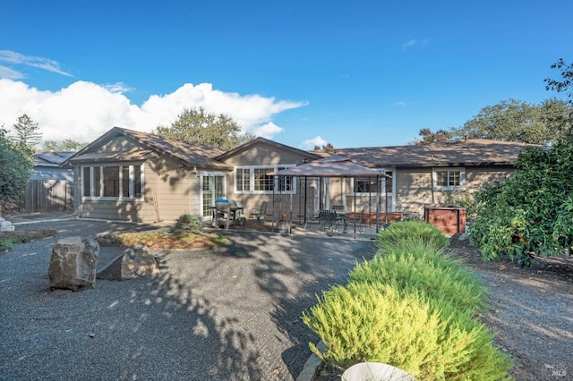 ranch-style home featuring a patio area