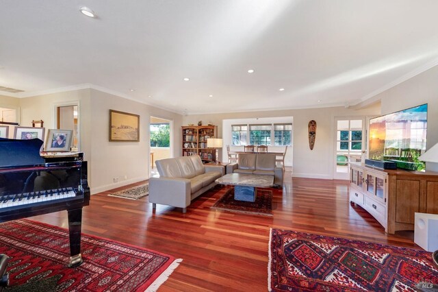 living room featuring crown molding and hardwood / wood-style flooring