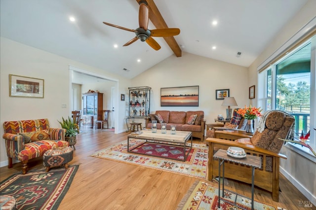 living room with vaulted ceiling with beams, hardwood / wood-style flooring, and ceiling fan