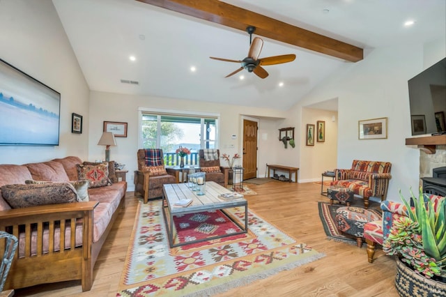 living room featuring light hardwood / wood-style flooring, beamed ceiling, high vaulted ceiling, and ceiling fan