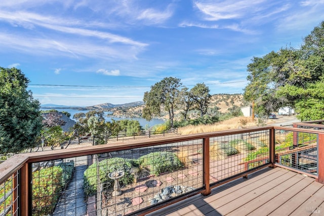 wooden terrace featuring a water and mountain view