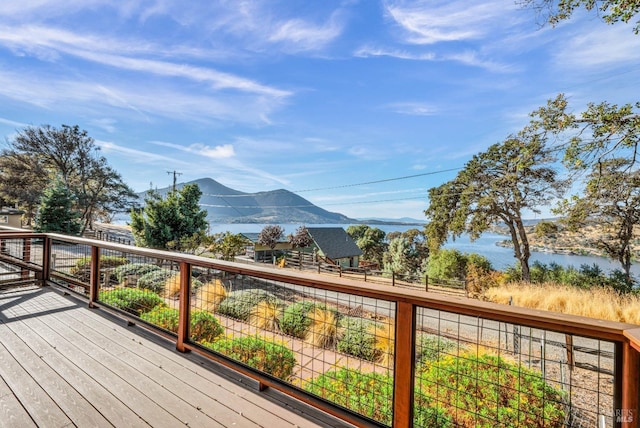 wooden terrace with a water and mountain view