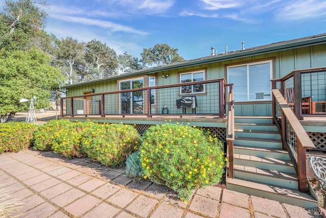 rear view of house featuring a patio and a deck