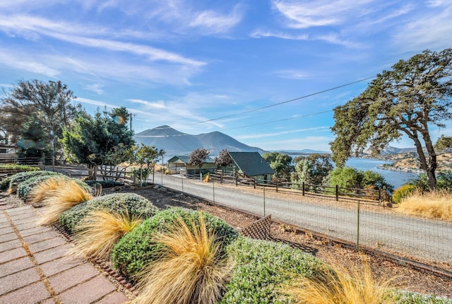 view of mountain feature featuring a water view and a rural view