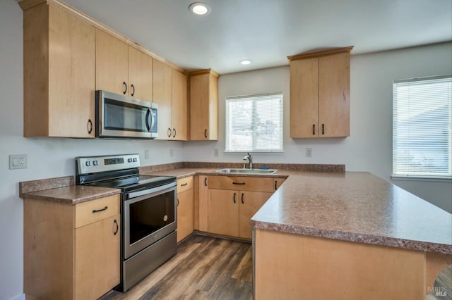 kitchen featuring light brown cabinetry, appliances with stainless steel finishes, and sink