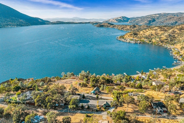 drone / aerial view featuring a water and mountain view