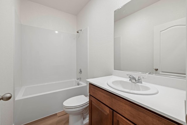 full bathroom with shower / tub combination, vanity, toilet, and wood finished floors