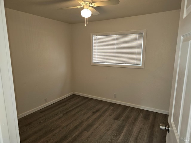 empty room featuring ceiling fan and dark hardwood / wood-style flooring