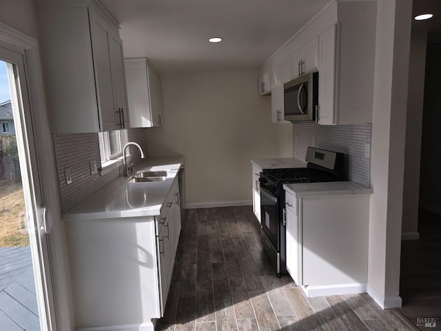 kitchen featuring white cabinetry, a healthy amount of sunlight, stainless steel appliances, and sink