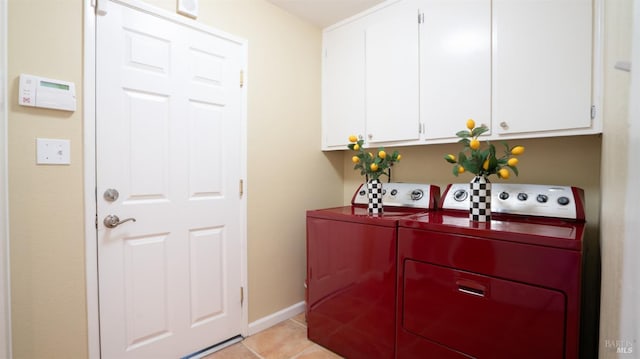 laundry room with cabinets, washer and dryer, and light tile patterned floors