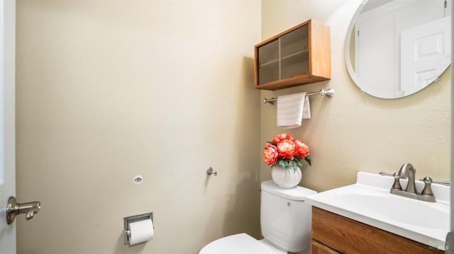 bathroom with toilet and vanity