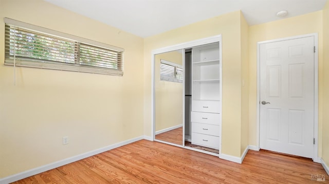 unfurnished bedroom with light hardwood / wood-style floors and a closet