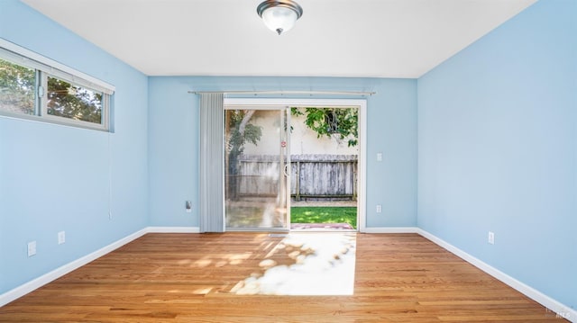 empty room with light hardwood / wood-style flooring