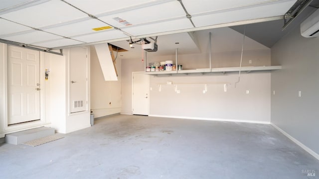 garage featuring a garage door opener and an AC wall unit