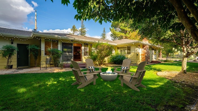 back of property featuring a lawn and a fire pit