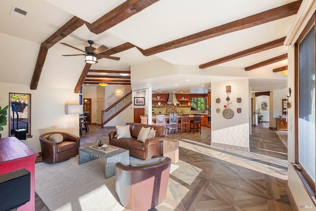 living room featuring ceiling fan, vaulted ceiling with beams, parquet floors, bar area, and plenty of natural light