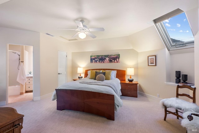 carpeted bedroom featuring connected bathroom, a skylight, and ceiling fan