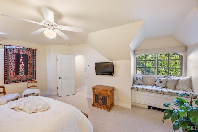 bedroom featuring light colored carpet, vaulted ceiling, and ceiling fan