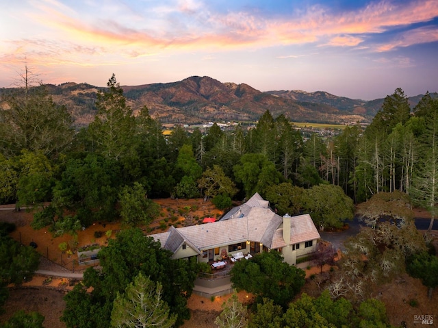 aerial view at dusk featuring a mountain view