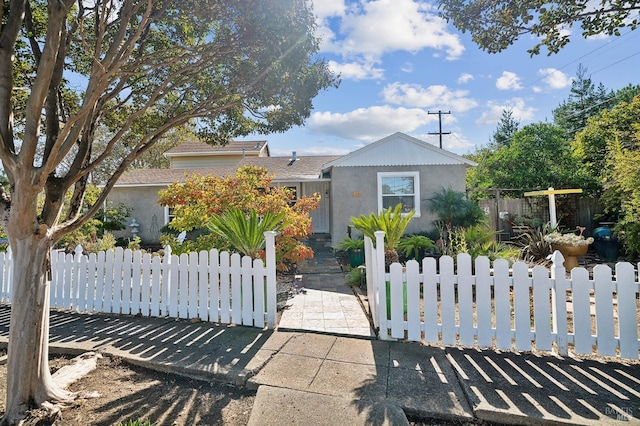 view of front of house with a fenced front yard and stucco siding