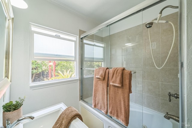 bathroom featuring enclosed tub / shower combo and crown molding