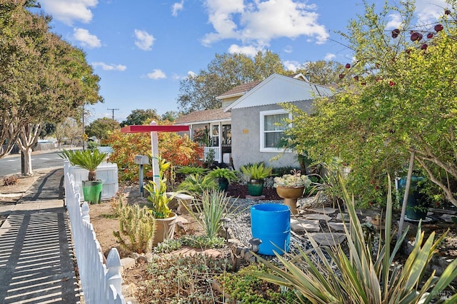 view of side of home with fence and stucco siding