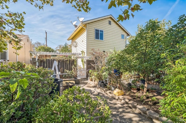 rear view of property featuring fence