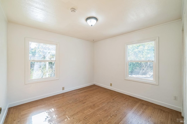 empty room with wood finished floors and baseboards