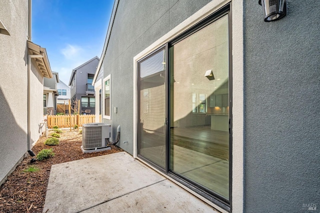 exterior space featuring a residential view, central AC, and fence