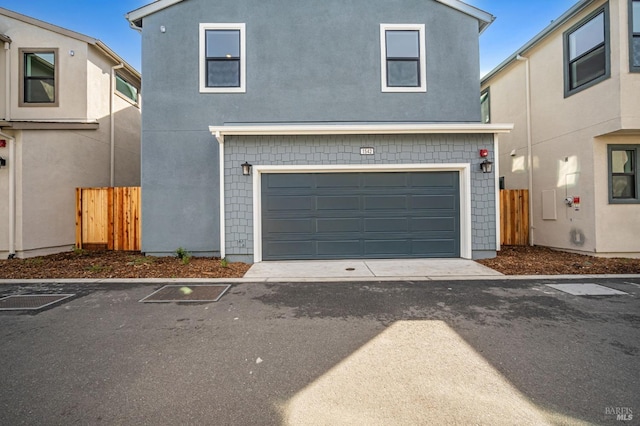 view of front of property with a garage and fence
