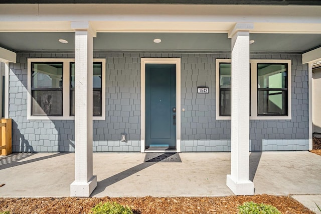 view of exterior entry with covered porch