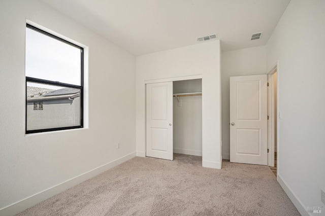 unfurnished bedroom featuring carpet flooring, baseboards, and visible vents