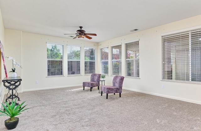 sitting room featuring carpet floors and ceiling fan