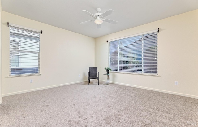 carpeted spare room with ceiling fan