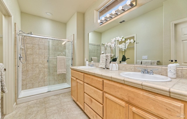 bathroom with vanity, tile patterned flooring, and a shower with door