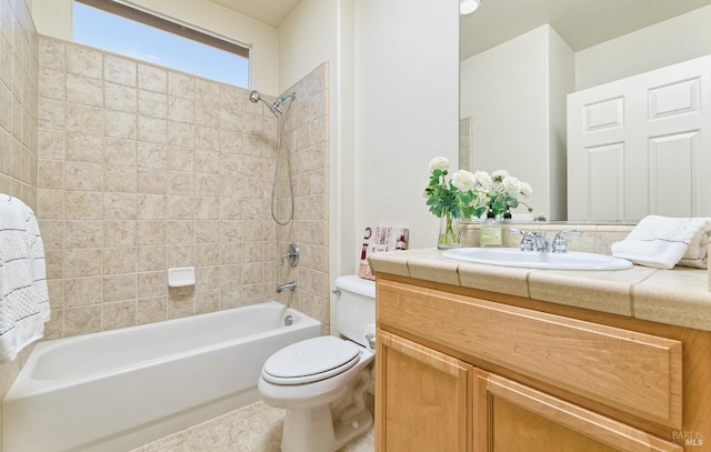 full bathroom featuring vanity, toilet, and tiled shower / bath combo