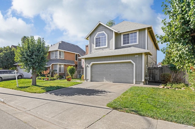 traditional home with a garage, driveway, fence, and a front lawn