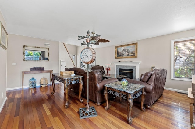 living room featuring hardwood / wood-style flooring and ceiling fan