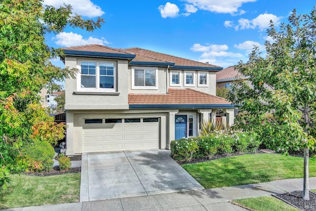 view of front of house featuring a garage and a front lawn