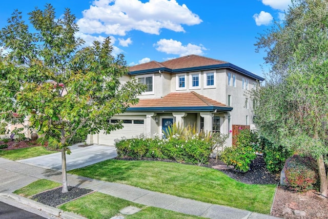 mediterranean / spanish-style house featuring a garage and a front yard