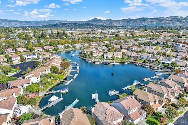 drone / aerial view featuring a water and mountain view