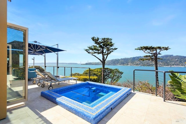 view of pool with a water view and an in ground hot tub